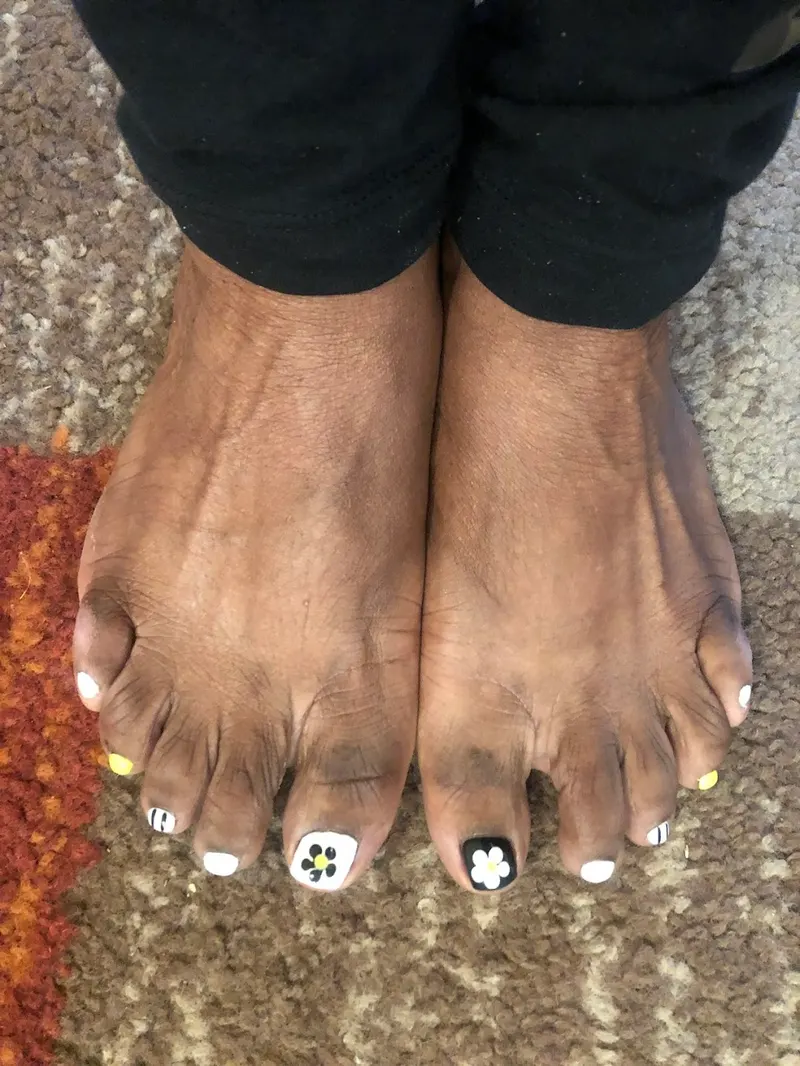 Detailed pedicure with custom nail art on the toes