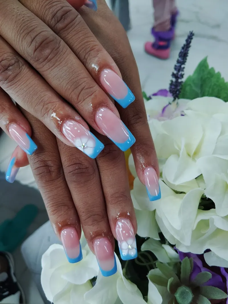 Long nails with colorful art and a soft white floral accent
