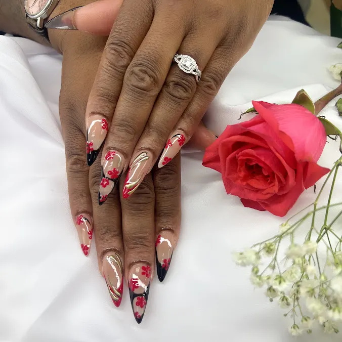 Red and white marble nails with a glossy rose-accented finish