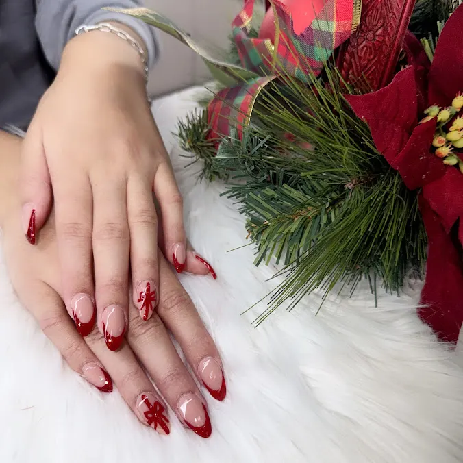 Festive red French nails with hand-painted snowflake art